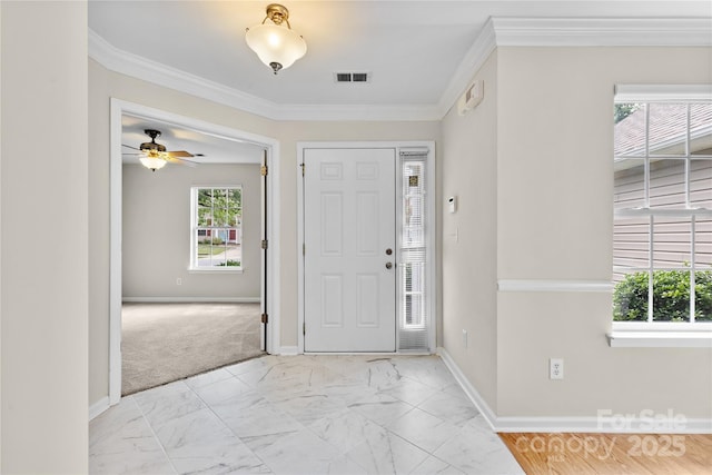 3008 Cornflower Ln, Indian Trail, NC 28079 - entrance foyer featuring light marble finish flooring, crown molding, ceiling fan, and light colored carpet