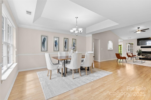 3008 Cornflower Ln, Indian Trail, NC 28079 - dining area with a raised ceiling, light wood-type flooring, a chandelier, and ceiling fan