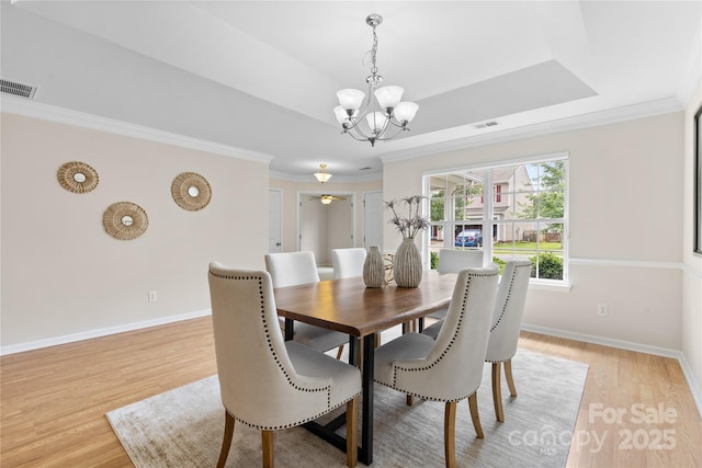 3008 Cornflower Ln, Indian Trail, NC 28079 - dining space with a chandelier, light wood-style flooring, and ornamental molding