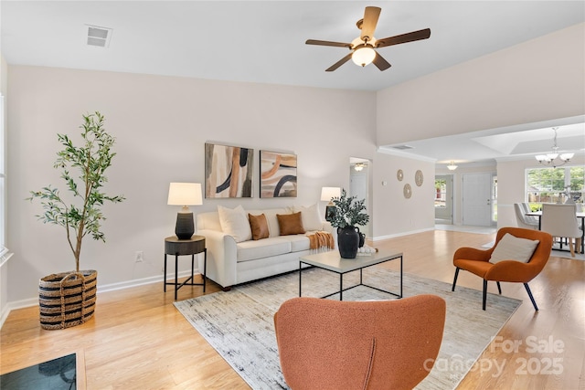 3008 Cornflower Ln, Indian Trail, NC 28079 - living room featuring wood finished floors, a ceiling fan, a chandelier, and vaulted ceiling