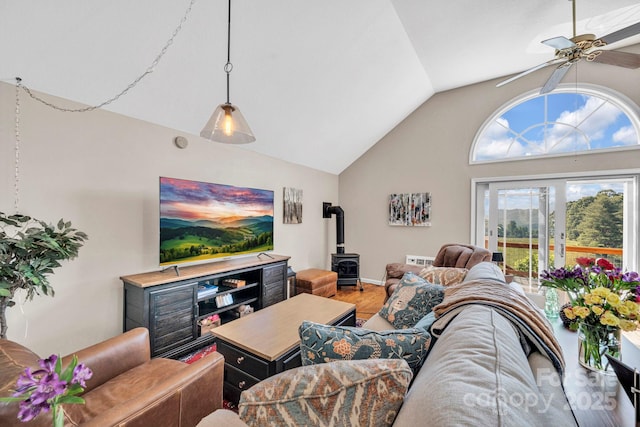 540 Upper Paw Paw Rd, Marshall, NC 28753 - living room featuring a wood stove, wood finished floors, a ceiling fan, and high vaulted ceiling