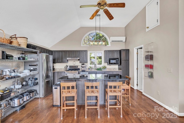 540 Upper Paw Paw Rd, Marshall, NC 28753 - kitchen featuring stainless steel appliances, a wall mounted air conditioner, a ceiling fan, high vaulted ceiling, and under cabinet range hood