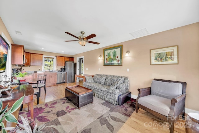 540 Upper Paw Paw Rd, Marshall, NC 28753 - living room with light wood-style floors, a ceiling fan, and baseboards