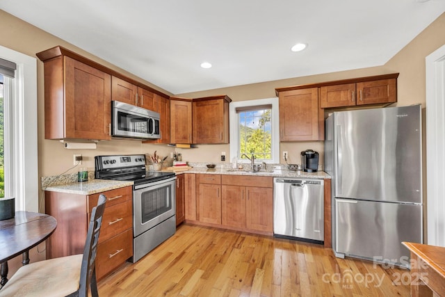 540 Upper Paw Paw Rd, Marshall, NC 28753 - kitchen with stainless steel appliances, a sink, light wood-style flooring, brown cabinets, and recessed lighting