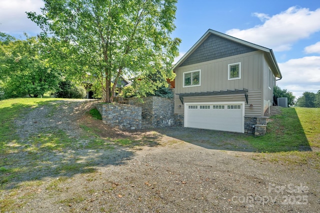 540 Upper Paw Paw Rd, Marshall, NC 28753 - view of side of property with central AC, board and batten siding, driveway, stone siding, and an attached garage