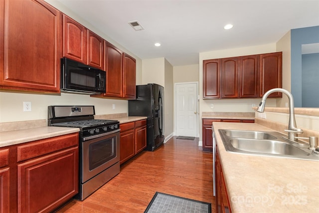 237 Lylic Woods Dr, Fort Mill, SC 29715 - kitchen featuring black appliances, a sink, light countertops, wood finished floors, and recessed lighting