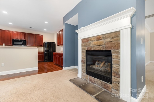 237 Lylic Woods Dr, Fort Mill, SC 29715 - kitchen with black appliances, a fireplace, dark wood-style floors, dark colored carpet, and recessed lighting