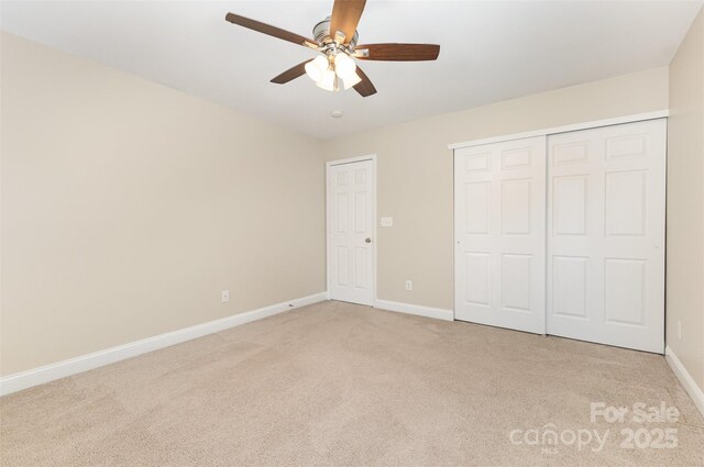 237 Lylic Woods Dr, Fort Mill, SC 29715 - unfurnished bedroom with light carpet, baseboards, a closet, and a ceiling fan