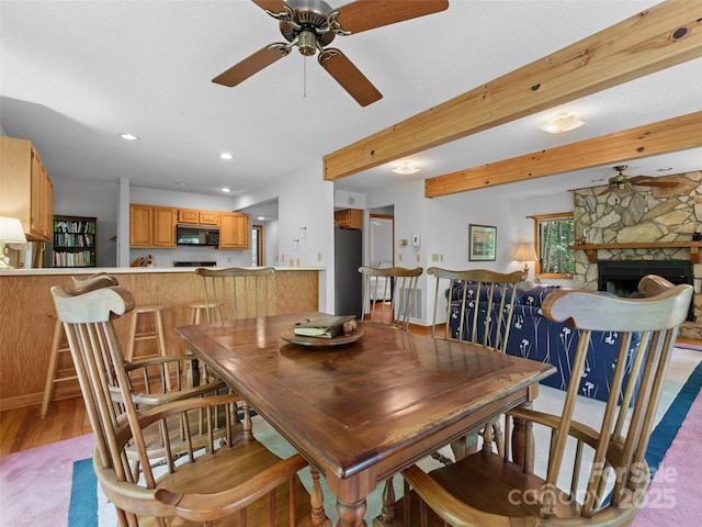 43 Hungryneck Hollow Ln, Saluda, NC 28773 - dining space with a ceiling fan, wood finished floors, recessed lighting, a fireplace, and beamed ceiling