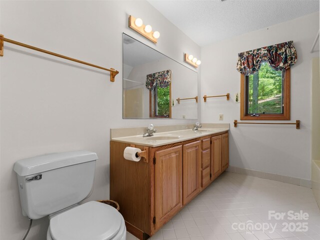 43 Hungryneck Hollow Ln, Saluda, NC 28773 - bathroom with toilet, double vanity, tile patterned flooring, a shower, and a textured ceiling