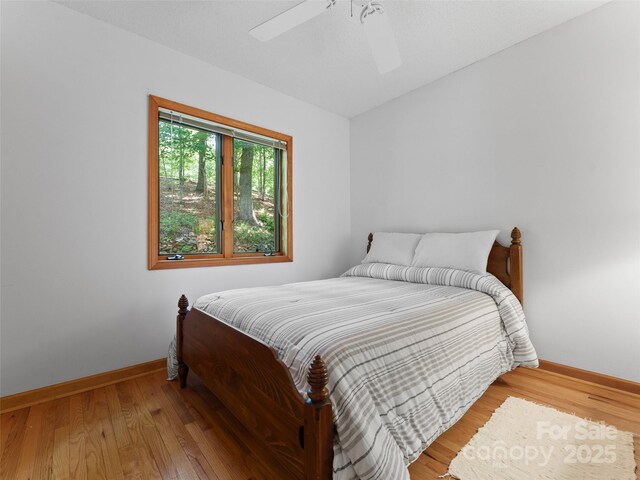 43 Hungryneck Hollow Ln, Saluda, NC 28773 - bedroom with baseboards, wood finished floors, and a ceiling fan