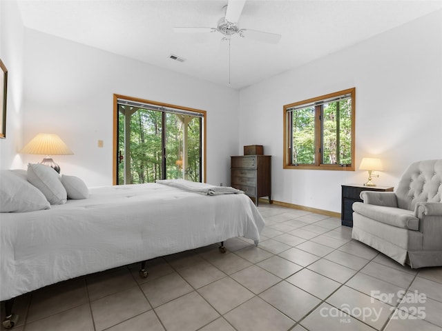 43 Hungryneck Hollow Ln, Saluda, NC 28773 - bedroom featuring multiple windows, light tile patterned floors, a ceiling fan, and baseboards
