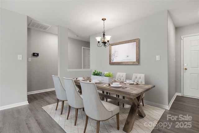 7315 Gasper Ln, Fort Mill, SC 29707 - dining space with light wood-type flooring, a chandelier, and baseboards