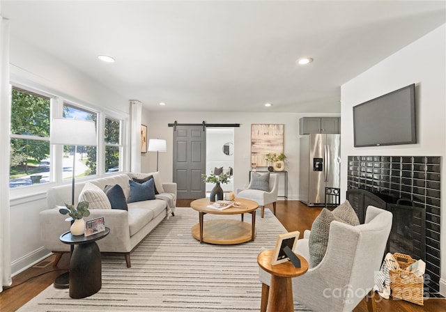 1027 Dresden Dr W, Charlotte, NC 28205 - living area with wood finished floors, a barn door, and recessed lighting