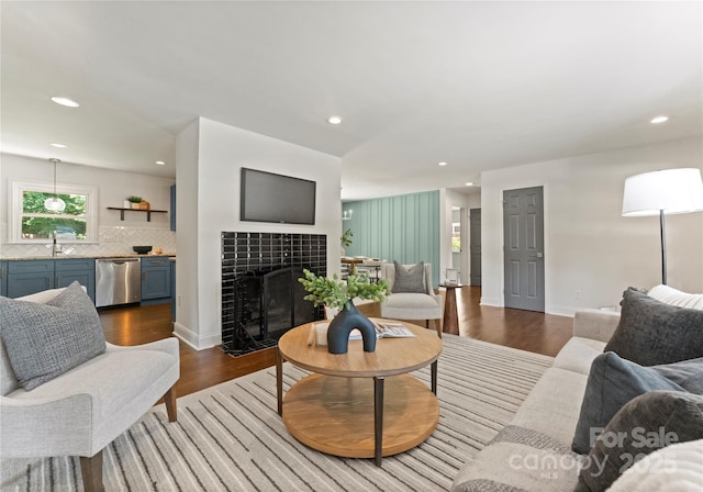 1027 Dresden Dr W, Charlotte, NC 28205 - living area with dark wood-style floors, recessed lighting, and a tiled fireplace