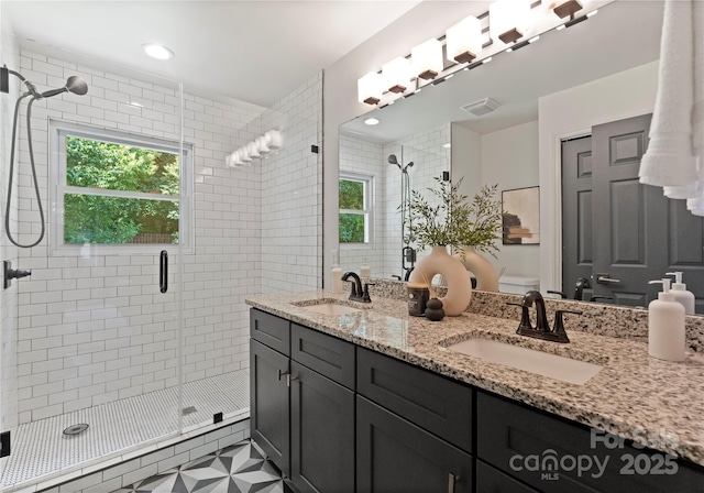 1027 Dresden Dr W, Charlotte, NC 28205 - bathroom featuring double vanity, a shower stall, and healthy amount of natural light