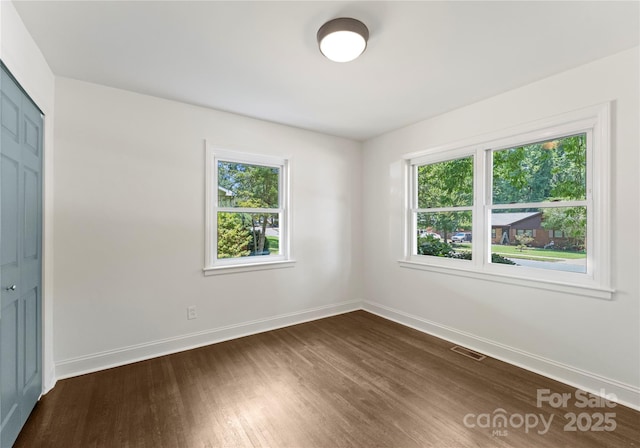 1027 Dresden Dr W, Charlotte, NC 28205 - unfurnished bedroom with dark wood-style flooring and a closet