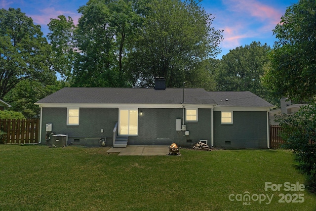 1027 Dresden Dr W, Charlotte, NC 28205 - back of house with entry steps, crawl space, brick siding, a chimney, and a fire pit