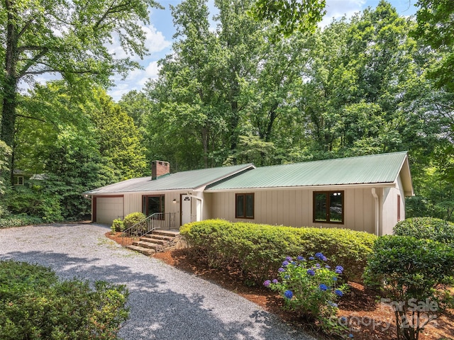 164 Beechwood Dr W, Columbus, NC 28722 - ranch-style home with a garage, a chimney, gravel driveway, and metal roof