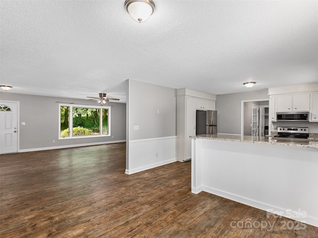 164 Beechwood Dr W, Columbus, NC 28722 - kitchen with appliances with stainless steel finishes, a textured ceiling, white cabinets, dark wood-type flooring, and light stone counters