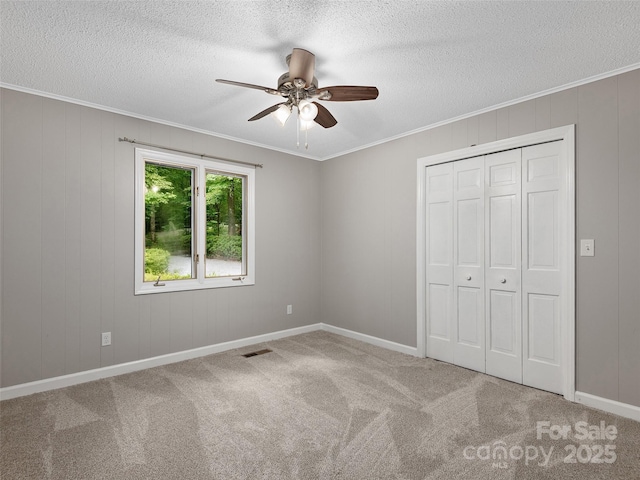 164 Beechwood Dr W, Columbus, NC 28722 - unfurnished bedroom with carpet flooring, a textured ceiling, crown molding, a closet, and ceiling fan
