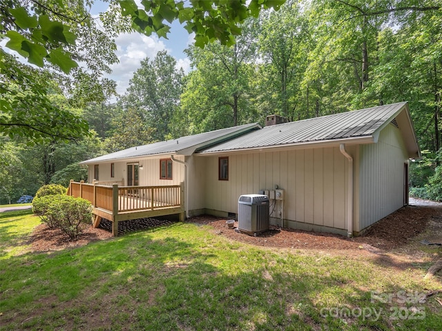 164 Beechwood Dr W, Columbus, NC 28722 - back of house with central AC unit, a yard, a wooden deck, metal roof, and a chimney