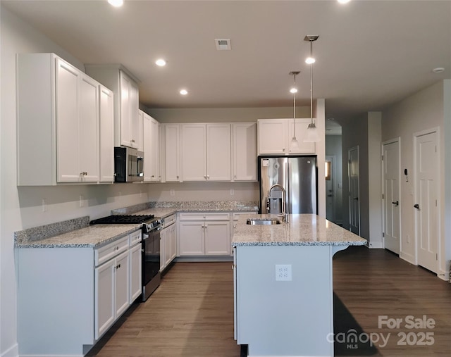 1598 Respect St, Concord, NC 28027 - kitchen with stainless steel appliances, a sink, dark wood finished floors, light stone counters, and recessed lighting