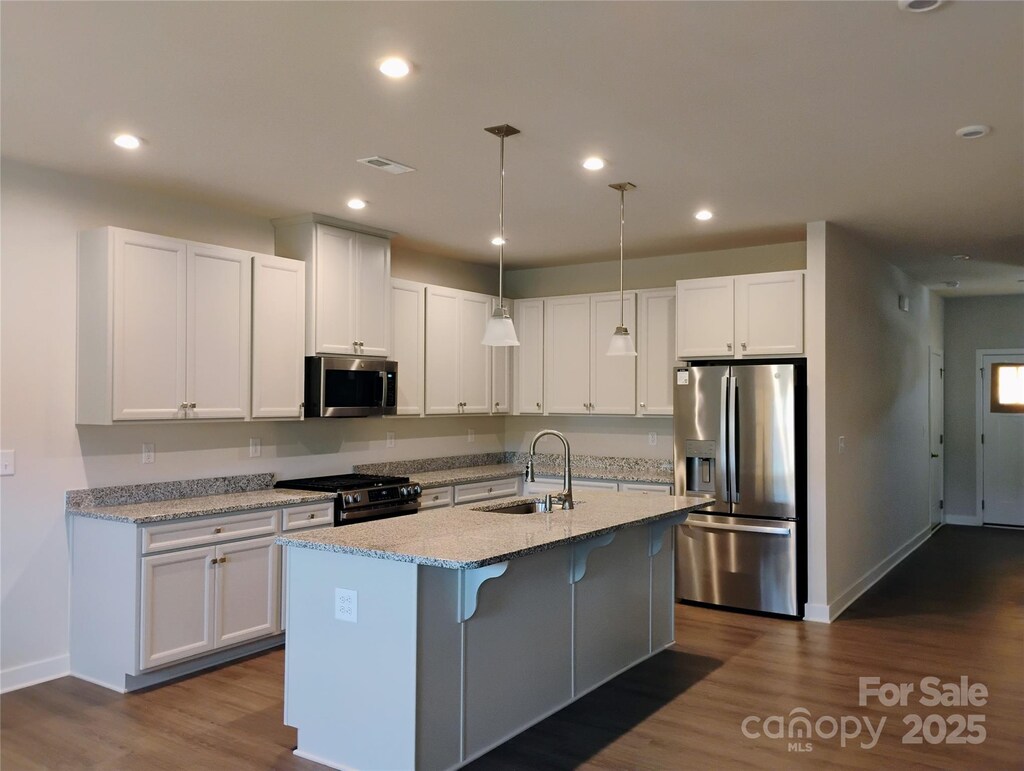 1598 Respect St, Concord, NC 28027 - kitchen featuring appliances with stainless steel finishes, a sink, white cabinetry, baseboards, and recessed lighting