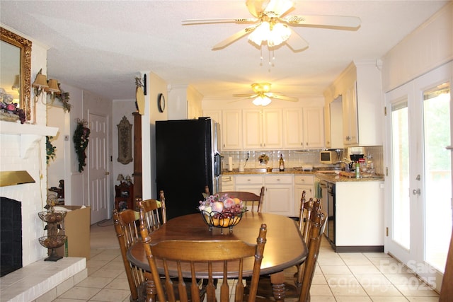 116 Woodbark Ln, Kings Mountain, NC 28086 - dining space featuring light tile patterned floors, a ceiling fan, a brick fireplace, and plenty of natural light