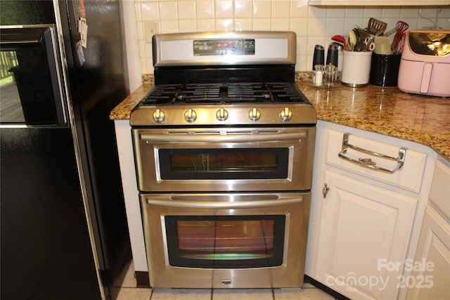 116 Woodbark Ln, Kings Mountain, NC 28086 - kitchen featuring appliances with stainless steel finishes, decorative backsplash, white cabinetry, and light stone countertops