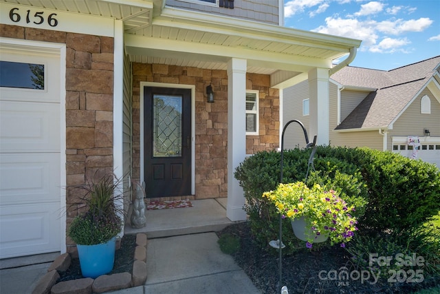 6156 Kilchurn Dr, Fort Mill, SC 29707 - entrance to property with stone siding, a garage, and covered porch