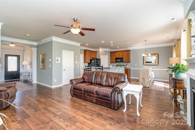 6156 Kilchurn Dr, Fort Mill, SC 29707 - living room featuring a ceiling fan, dark wood-style floors, decorative columns, ornamental molding, and a fireplace