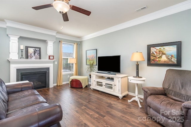6156 Kilchurn Dr, Fort Mill, SC 29707 - living area with crown molding, dark wood-type flooring, a ceiling fan, and a glass covered fireplace