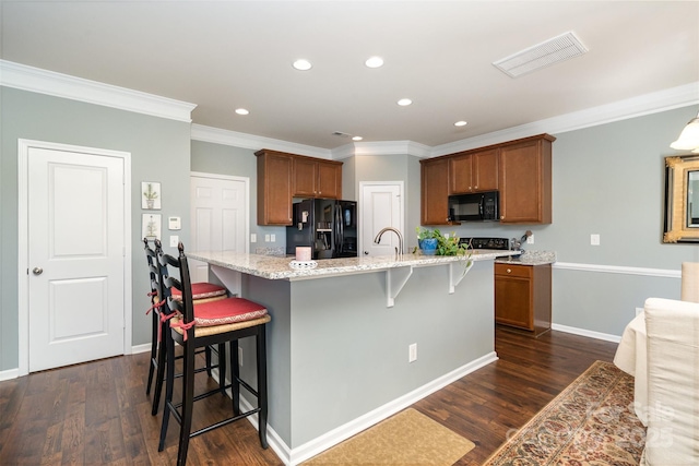 6156 Kilchurn Dr, Fort Mill, SC 29707 - kitchen with black appliances, recessed lighting, dark wood-style floors, brown cabinets, and crown molding