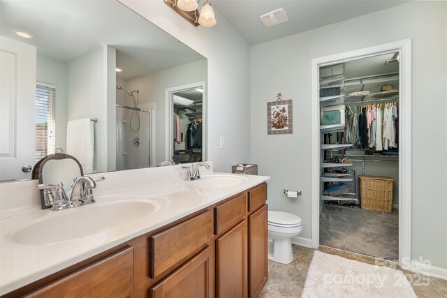 6156 Kilchurn Dr, Fort Mill, SC 29707 - full bathroom featuring a walk in closet, double vanity, a stall shower, and tile patterned flooring