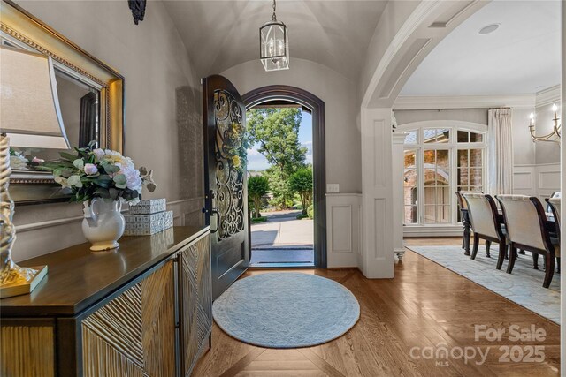 617 Beauhaven Ln, Waxhaw, NC 28173 - foyer featuring a decorative wall, arched walkways, wood finished floors, and a wainscoted wall