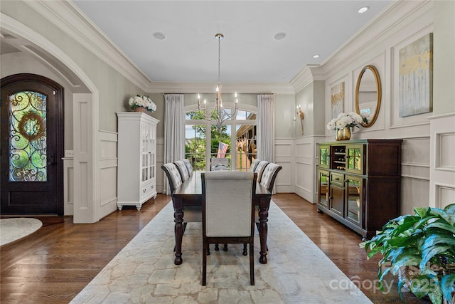 617 Beauhaven Ln, Waxhaw, NC 28173 - dining area featuring a decorative wall, a chandelier, ornamental molding, dark wood finished floors, and wainscoting