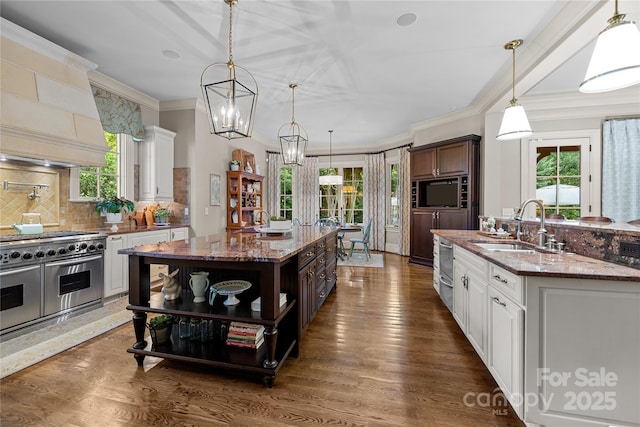 617 Beauhaven Ln, Waxhaw, NC 28173 - kitchen featuring double oven range, a center island with sink, open shelves, tasteful backsplash, and ornamental molding