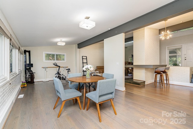 5742 Murrayhill Rd, Charlotte, NC 28210 - dining area featuring wood finished floors, lofted ceiling, and a chandelier