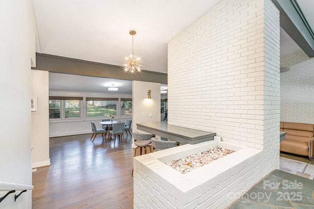 5742 Murrayhill Rd, Charlotte, NC 28210 - kitchen with wood finished floors and brick wall