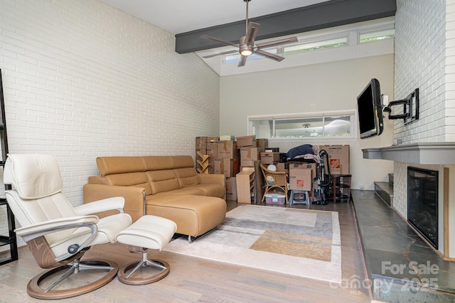 5742 Murrayhill Rd, Charlotte, NC 28210 - living room with ceiling fan, a large fireplace, a high ceiling, wood finished floors, and brick wall