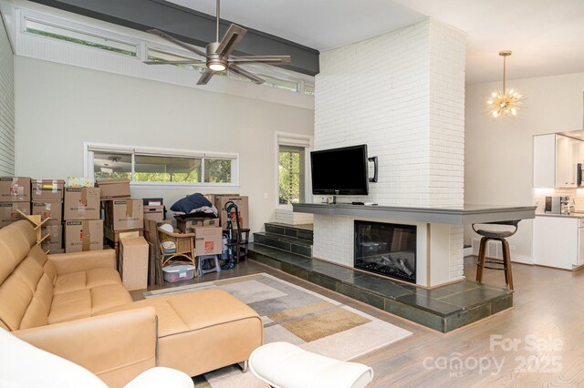 5742 Murrayhill Rd, Charlotte, NC 28210 - living area featuring a towering ceiling, a ceiling fan, and wood finished floors