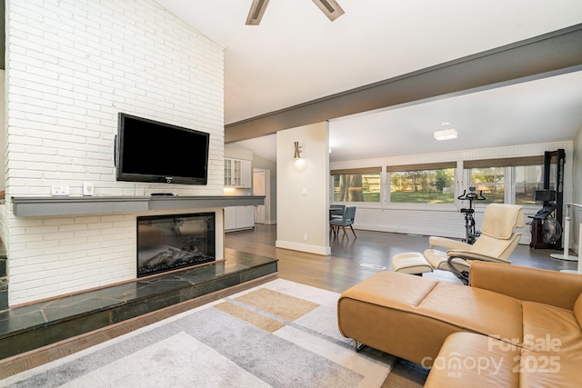 5742 Murrayhill Rd, Charlotte, NC 28210 - living room with wood finished floors, a ceiling fan, and a fireplace