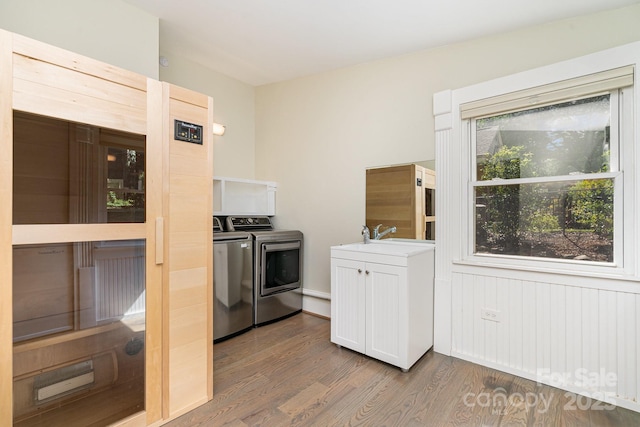 5742 Murrayhill Rd, Charlotte, NC 28210 - kitchen with washing machine and dryer, dark wood-style floors, white cabinets, and light countertops