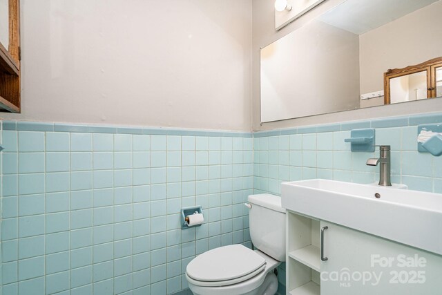 5742 Murrayhill Rd, Charlotte, NC 28210 - bathroom featuring tile walls, wainscoting, and vanity