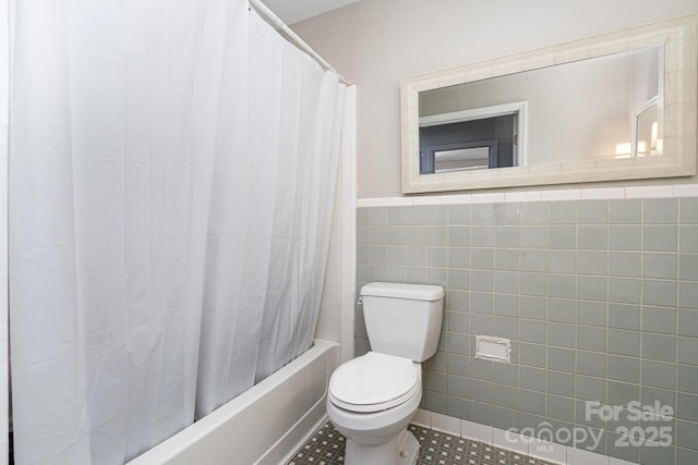 5742 Murrayhill Rd, Charlotte, NC 28210 - bathroom with shower / tub combo with curtain, tile walls, wainscoting, and tile patterned floors