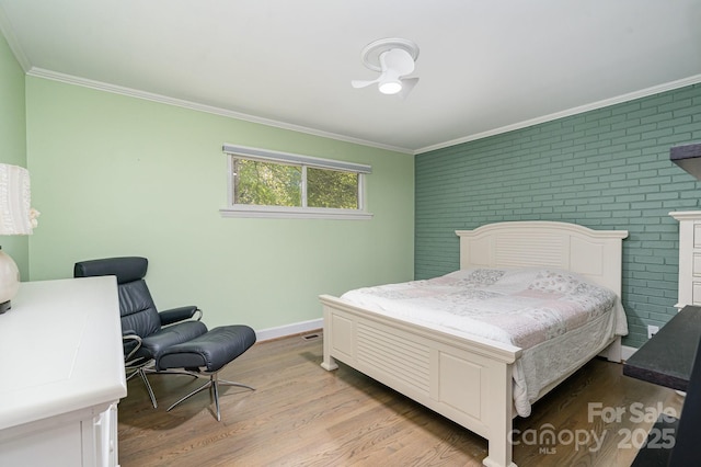 5742 Murrayhill Rd, Charlotte, NC 28210 - bedroom featuring ornamental molding, brick wall, and light wood-style flooring