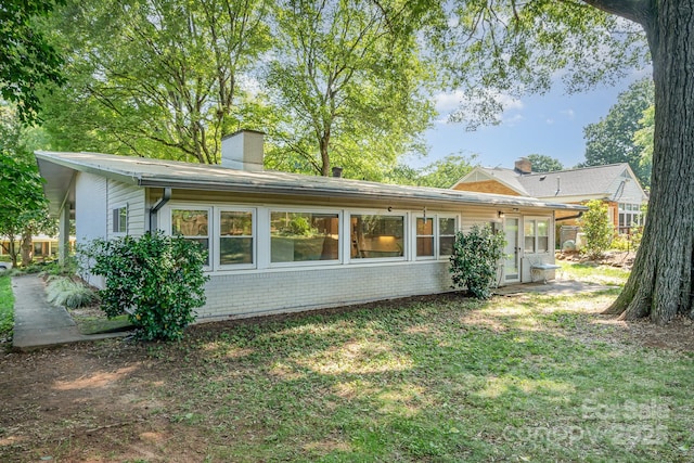 5742 Murrayhill Rd, Charlotte, NC 28210 - rear view of house with a chimney, a yard, and brick siding