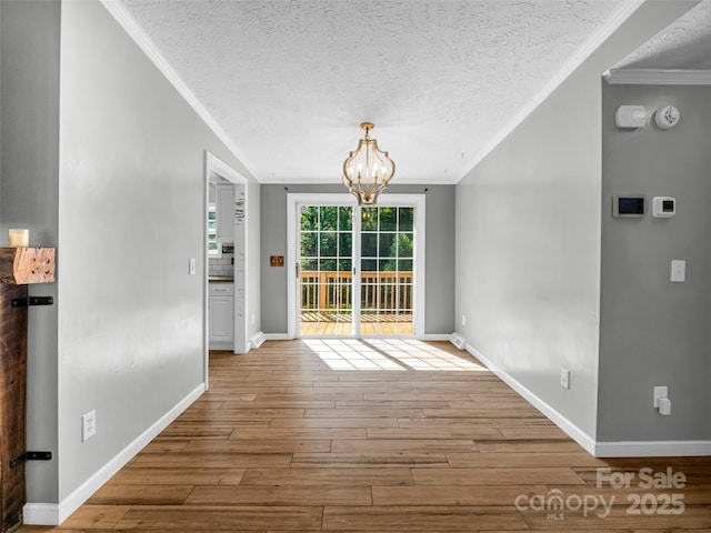 2941 Nix Creek Rd, Marion, NC 28752 - unfurnished dining area featuring crown molding, a chandelier, wood finished floors, baseboards, and a textured ceiling