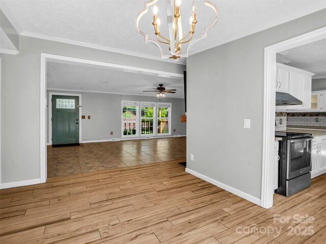 2941 Nix Creek Rd, Marion, NC 28752 - unfurnished dining area featuring baseboards, ceiling fan, light wood-style floors, a chandelier, and crown molding